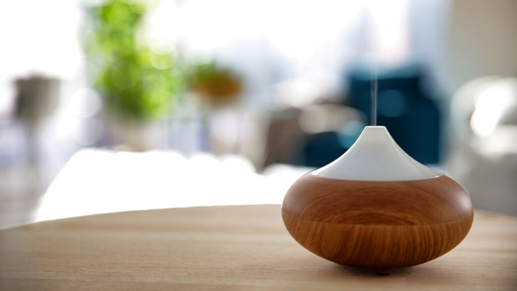 Electric oil diffuser on blurred room background